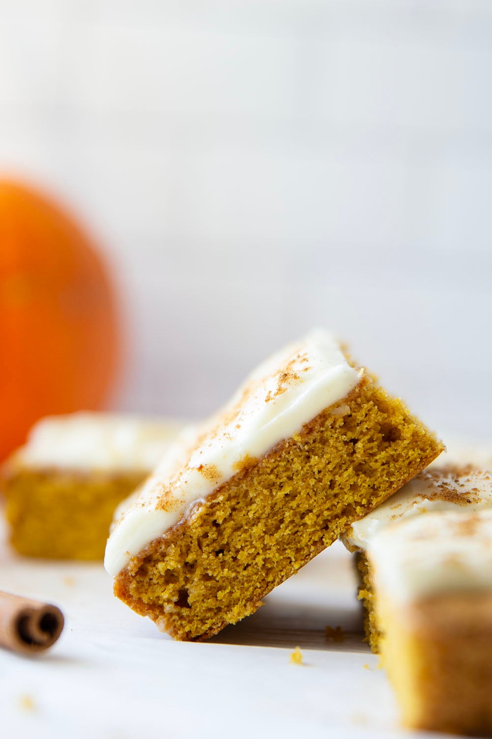 These pumpkin spice bars feature a soft, cake-like texture, lots of pumpkin spice goodness, and a silky cream cheese frosting on top.