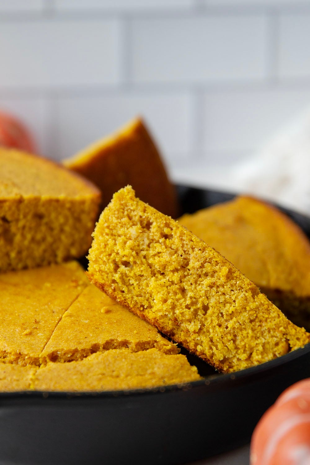 Plenty of fall spices and pumpkin collide in this soft and perfectly spiced pumpkin cornbread that pairs like a dream with a bowl of chili!