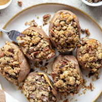Piled high with buttery pecan streusel and baked twice to perfection, these twice-baked sweet potatoes will be the biggest hit of your Thanksgiving dinner!