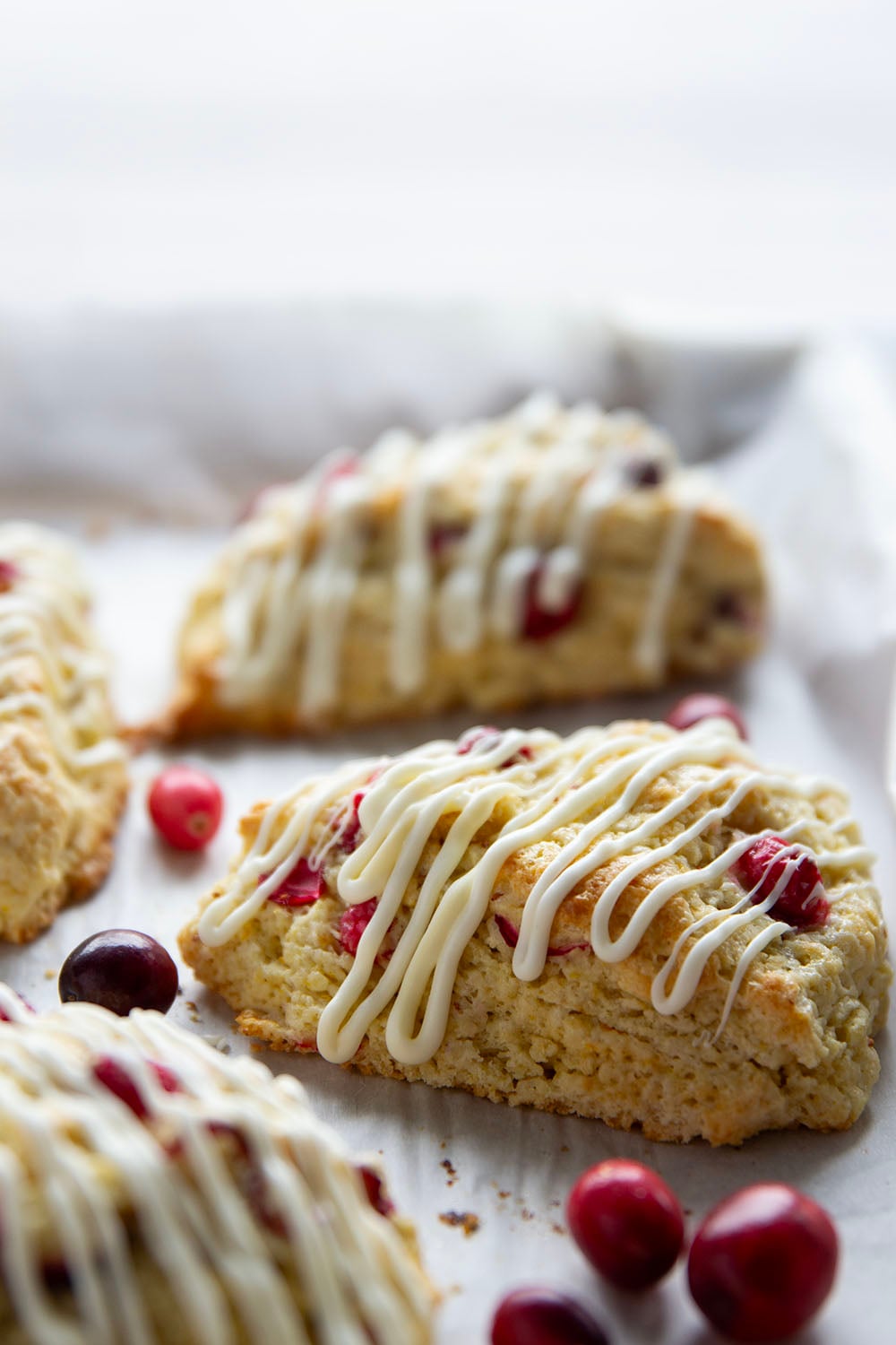 Juicy tart cranberries and a thick drizzle of white chocolate are the perfect holiday pairing in these flaky white chocolate cranberry scones.