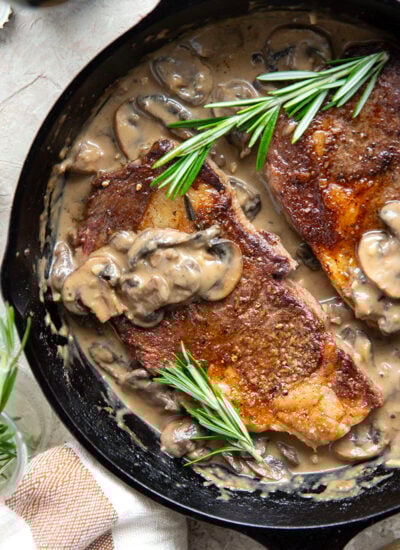 Learn how to cook a perfect restaurant-style ribeye steak with mushroom sauce with this keeper recipe. The steak sears up buttery tender every time and is fantastic with a creamy stout mushroom sauce draped over top.