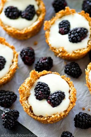 A luscious, no-bake cheesecake filling nestled inside little coconut macaroon crusts and topped with lots of fresh blackberries!---these easy tartlets are SUPER-popular at spring gatherings!