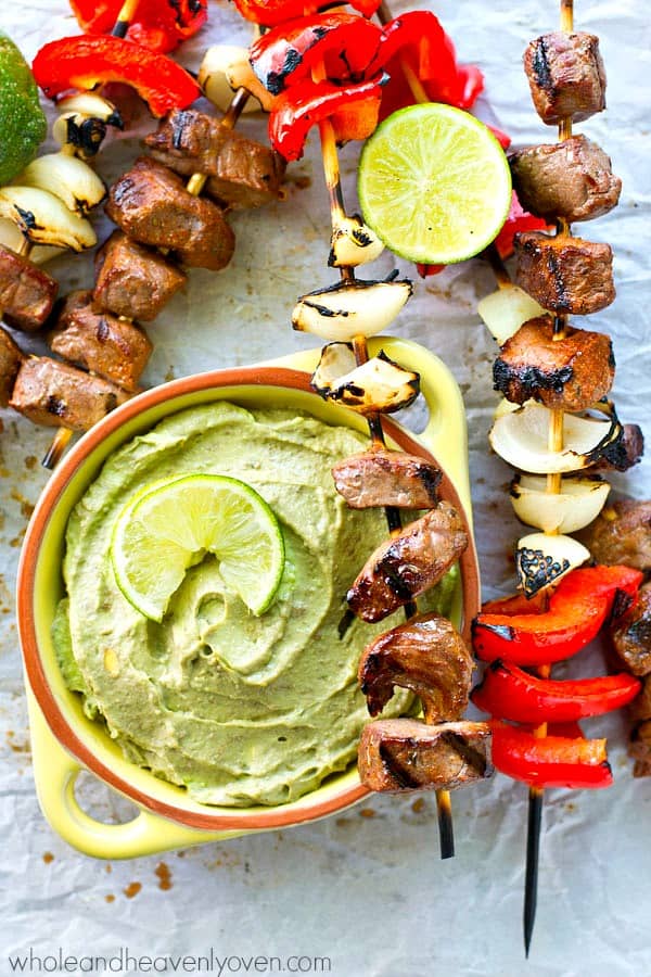 Simple grilled steak and pepper kebabs with just a little kick of spice that go perfectly with a cool and creamy avocado dip.---These steak kebabs are SO easy to make!