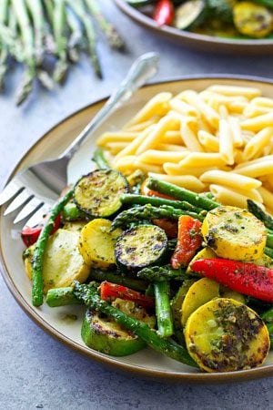 Covered in flavorful pesto and grilled to smoky perfection, these grilled vegetables and penne pasta are an easy and totally amazing vegetarian dinner for the summer!