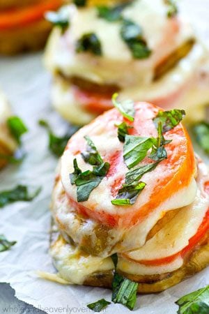 These layered caprese stacks feature fresh heirloom tomatoes, eggplant, and plenty of mozzarella cheese and fresh basil.---Ready in 15 minutes with only FIVE ingredients!
