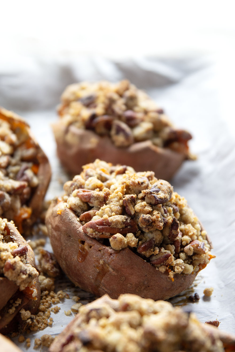 Piled high with buttery pecan streusel and baked twice to perfection, these twice-baked sweet potatoes will be the biggest hit of your Thanksgiving dinner!