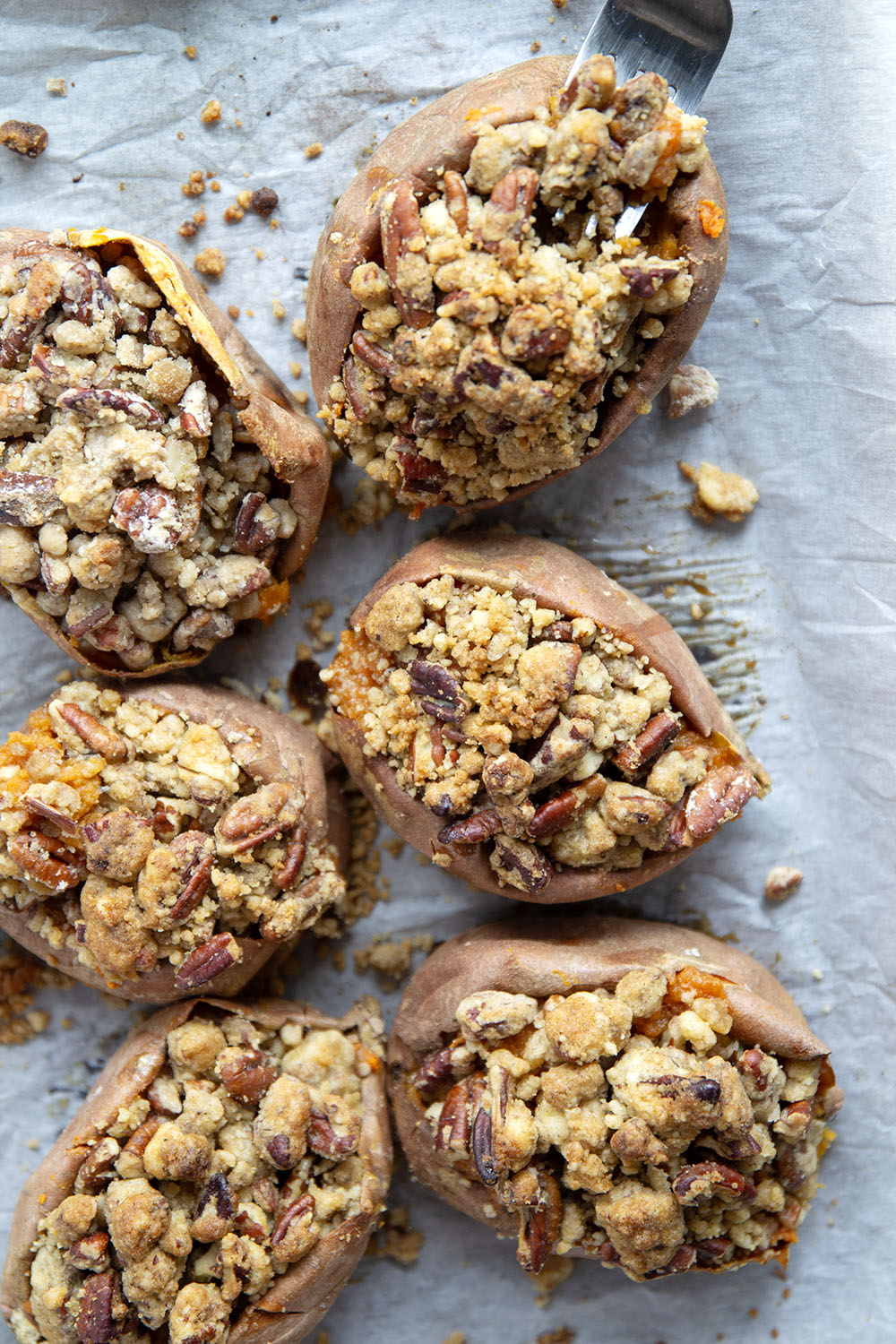 Piled high with buttery pecan streusel and baked twice to perfection, these twice-baked sweet potatoes will be the biggest hit of your Thanksgiving dinner!