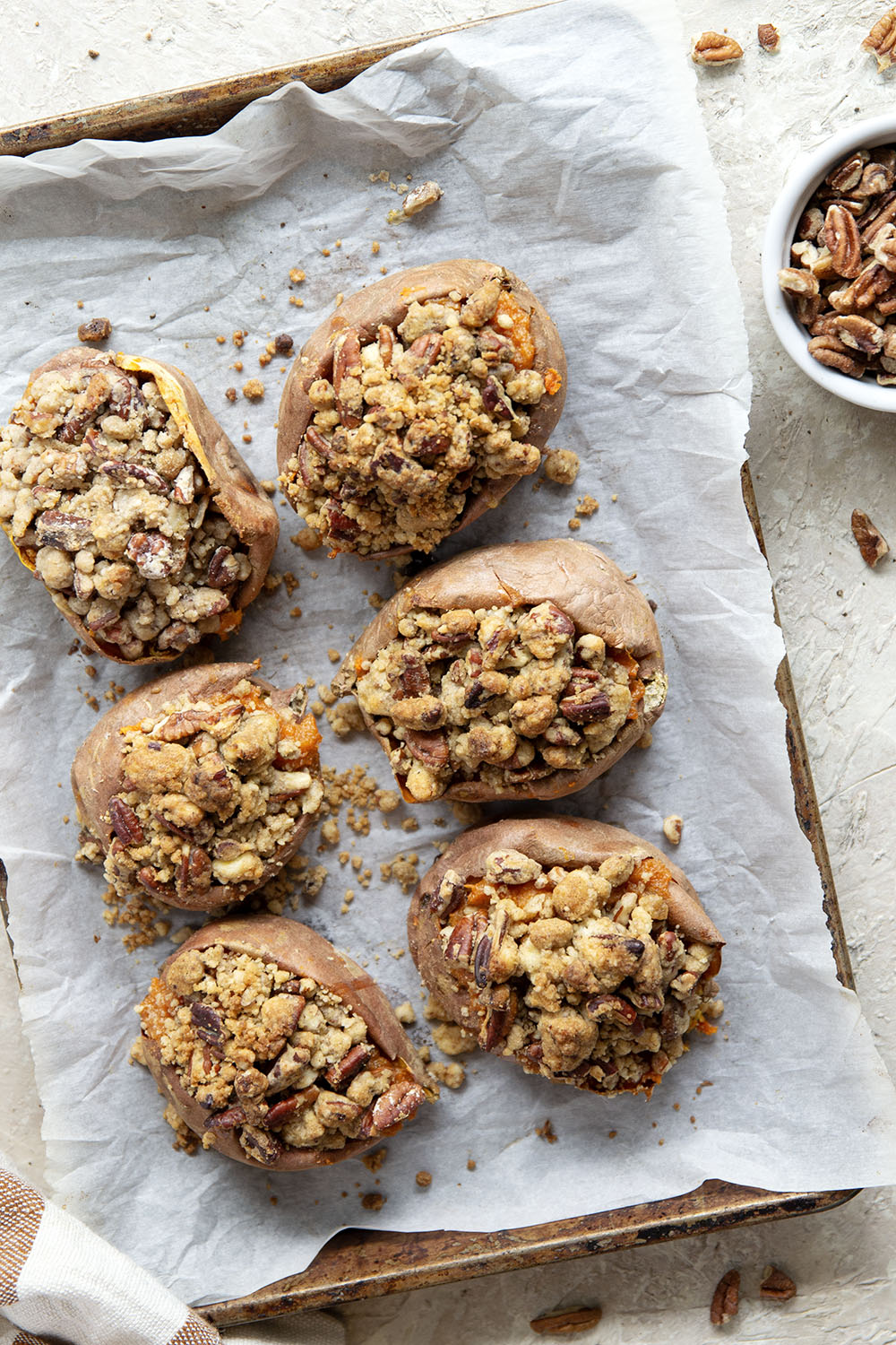 Piled high with buttery pecan streusel and baked twice to perfection, these twice-baked sweet potatoes will be the biggest hit of your Thanksgiving dinner!