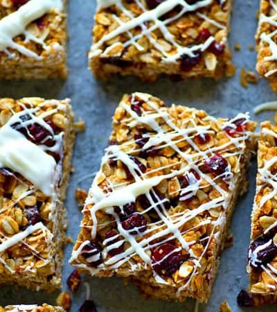 Cranberry bliss bars meet granola bar! These white chocolate cranberry bliss granola bars are so soft, chewy, packed with tangy cranberries, and drizzled with tons of white chocolate!