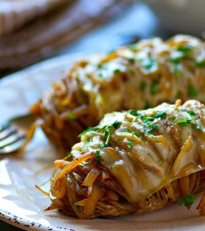 Hasselback baked potatoes are filled with tons of caramelized onions and topped off with Swiss cheese for one knock-out easy dinner side!