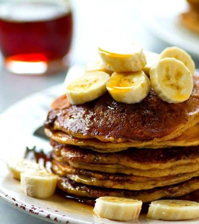 Thick and fluffy banana buttermilk pancakes are generously coated in a homemade cinnamon crunch topping for the ultimate pancake combo.---you will not be able to stack these high enough!