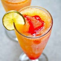 These tequila sunrise slushies are a frozen twist off of the classic cocktail and they're SO easy to blend up! Make a double batch because these sippers are gonna disappear fast.
