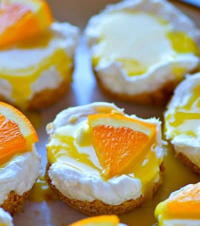 These creamy orange curd mini cheesecakes are completely no-bake and can be prepped within minutes! A tangy homemade orange curd on top makes them irresistible.