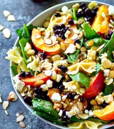 Loaded with fresh summer peaches and blueberries and tossed in a flavorful Asian dressing, this feta spinach pasta salad is going to become a staple on your summer salad lineup!