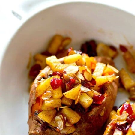 Stuffed with sweet caramelized apples and cranberries, these twice-baked sweet potatoes are a SUPER easy Thanksgiving side and so much better than any casserole!