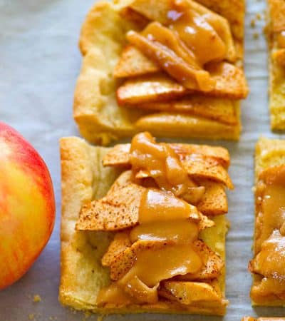 A soft sugar cookie crust collides with everything you love about caramel apples in this beautiful sugar cookie caramel apple slab pie! Perfect for a last-minute holiday dessert!