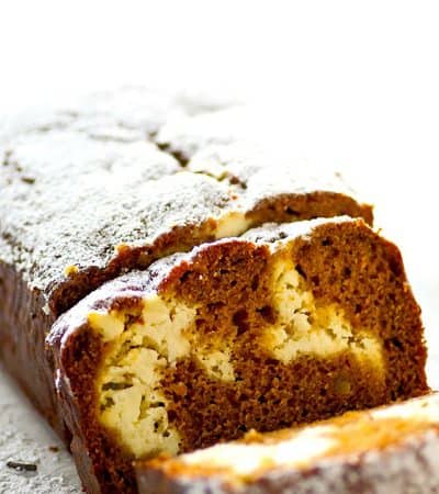 Soft, spiced gingerbread is filled with a luscious cheesecake swirl for the ultimate twist on gingerbread! This gingerbread cheesecake swirl quick bread is a holiday brunch must.