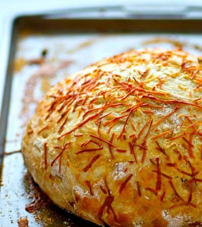 Flavorful caramelized onion and sharp asiago cheese are the perfect duo in this stunning asiago no-knead bread! Its made overnight for easy baking the next day and SO incredibly tender and flavorful!