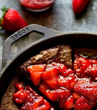 Incredibly fudgy deep-dish mocha brownie pie is piled high with juicy homemade strawberry preserves for the BEST brownie dessert you could ever dream of!