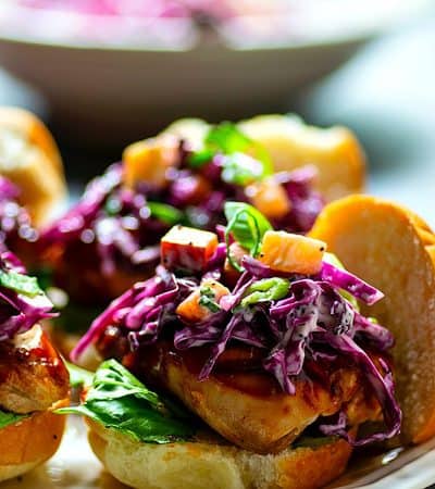 Barbecue Chicken Sliders with Peach Scallion Slaw - Massively flavorful barbecue chicken sliders are piled high with a sweet peach scallion slaw for the ULTIMATELY easy and crowd-pleasing summer appetizer!