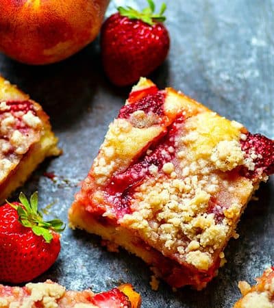 Strawberry Peach Crumb Buckle - Summer-fresh strawberries and peaches join forces in this streusel-covered strawberry peach crumb buckle that's a perfect summer coffee cake or dessert!