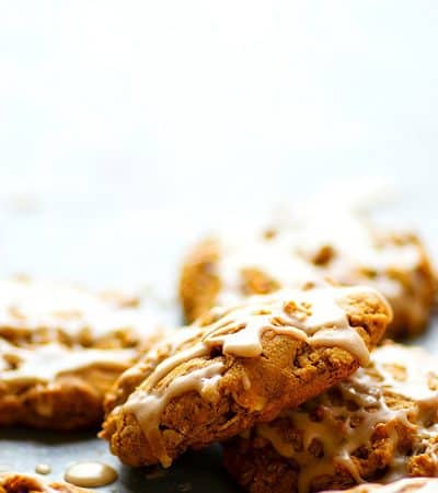 Iced Gingerbread Oatmeal Cookies - Packed with irresistible gingerbread flavors, super chewy, and draped in sweet vanilla icing, these iced gingerbread oatmeal cookies are a holiday cookie tray necessity!