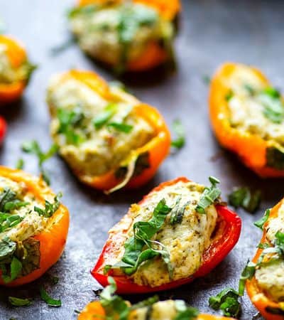 Pesto Stuffed Sweet Pepper Poppers - Stuffed with a super flavorful creamy pesto filling, these pesto stuffed sweet pepper poppers are SUPER addicting and the perfect little party app!