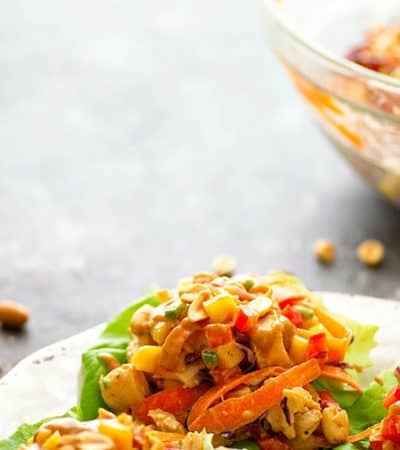 Spicy Peanut Thai Mango Chicken Lettuce Wraps - A creamy peanut sauce and spicy Thai flavors collide in these colorful mango chicken lettuce wraps that are a perfect lighter lunch or dinner!
