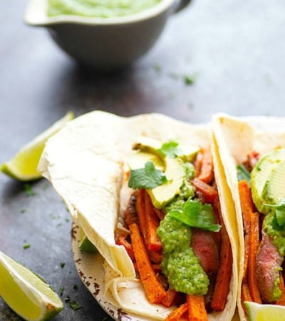 Jerk Sweet Potato Steak Tacos - Jerk-rubbed steak and roast sweet potatoes are piled into soft flour tortillas and topped with a creamy avocado salsa verde for an incredible twist on sweet potato steak tacos!