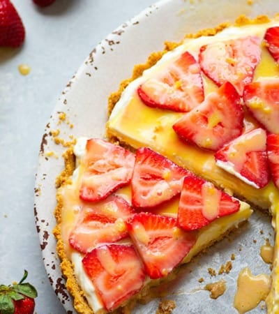 Incredibly light and silky strawberry cheesecake tart is the easiest no-bake dessert to make when you want an easy showstopper! You won't be able to get enough of the juicy strawberries, fluffy cheesecake filling, and tangy homemade lemon curd.