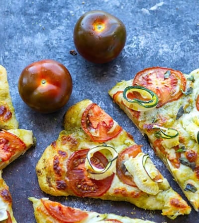 Tender zucchini, flavorful pesto, and juicy summer heirloom tomatoes make for the perfect summer-style pesto flatbread!