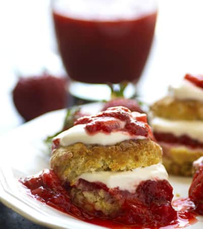 Strawberry rhubarb shortcake is the most amazing summer indulgence! Flaky homemade biscuits are filled with plenty of honey lemon whipped cream and tangy strawberry rhubarb sauce.