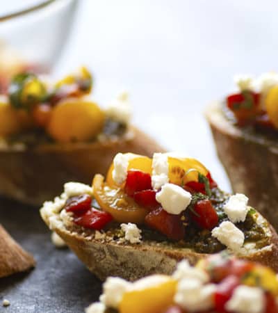 Tender roasted red peppers coupled with flavorful pesto and creamy goat cheese are an incredible flavor trio in this goat cheese bruschetta that's super impressive, incredibly easy, and perfect for entertaining!