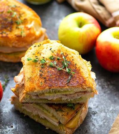 Turkey panini is layered with hearty turkey slices, crunchy apples, flavorful pesto, and gooey gouda cheese for one showstopper sandwich! -- this is the perfect panini for turkey leftovers!