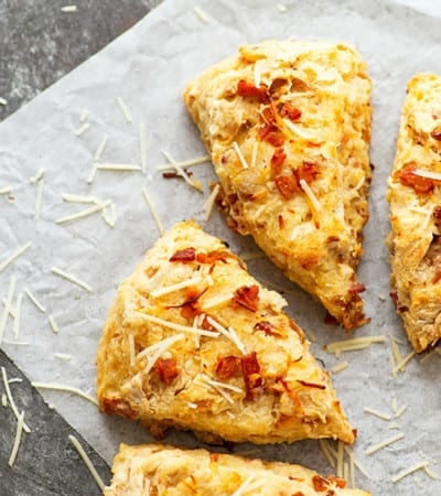 Sharp Asiago cheese and flavorful caramelized onion bits make for incredible savory flavors in these flaky bacon scones! They bake up in only 30 minutes and are a perfect savory breakfast pastry OR dinner side dish.