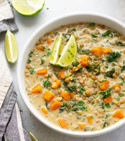 This cozy coconut curry lentil soup features tender sweet potatoes, soft lentils, and wilted kale in an incredibly flavorful creamy coconut curry broth. - so easy to prepare and completely vegan!
