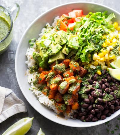 Blackened butternut squash burrito bowls are piled high with all the fixins' and a flavorful fresh mojo sauce for a healthy take on burrito bowls! Completely vegetarian AND vegan!