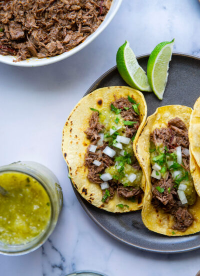 Instant pot barbacoa beef tacos feature a fall-apart-tender, spicy barbacoa beef made entirely in the instant pot and a sweet roasted pineapple tomatillo salsa for topping tacos.