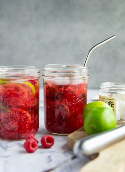 Bursting with fresh raspberries, mint, and lime, these raspberry mint mojitos are an easy cocktail to mix up for a crowd or just for chill poolside sipping!
