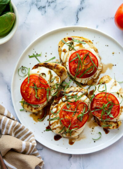 This grilled chicken margherita features grilled chicken topped with fresh mozzarella, juicy tomato slices, and lots of fresh basil and balsamic glaze.