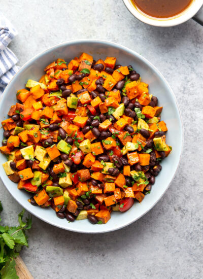 Spicy chipotle roasted sweet potatoes and a flavorful honey soy sauce vinaigrette dress up this sweet potato black bean salad into an incredible flavor-packed side dish or lunch salad!