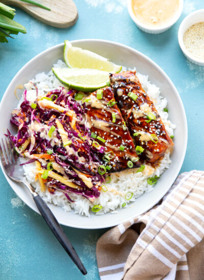 These teriyaki salmon bowls feature smoky grilled salmon marinated in a flavorful homemade teriyaki sauce and served in rice bowls with lots of spicy mango slaw.