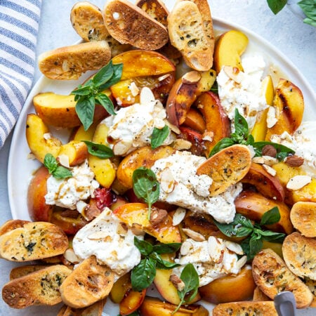 Tender grilled peaches and creamy burrata cheese are a match made in heaven in this summery appetizer! Serve these peaches and burrata with lots of toasted crostini for dipping.