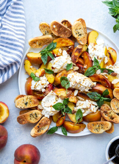 Tender grilled peaches and creamy burrata cheese are a match made in heaven in this summery appetizer! Serve these peaches and burrata with lots of toasted crostini for dipping.