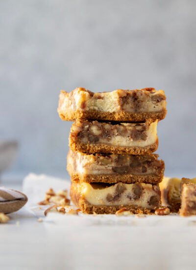 Silky cheesecake and a luxurious honey pecan pie topping are the perfect duo in these pecan pie cheesecake bars! They make a great addition to any holiday dessert table.