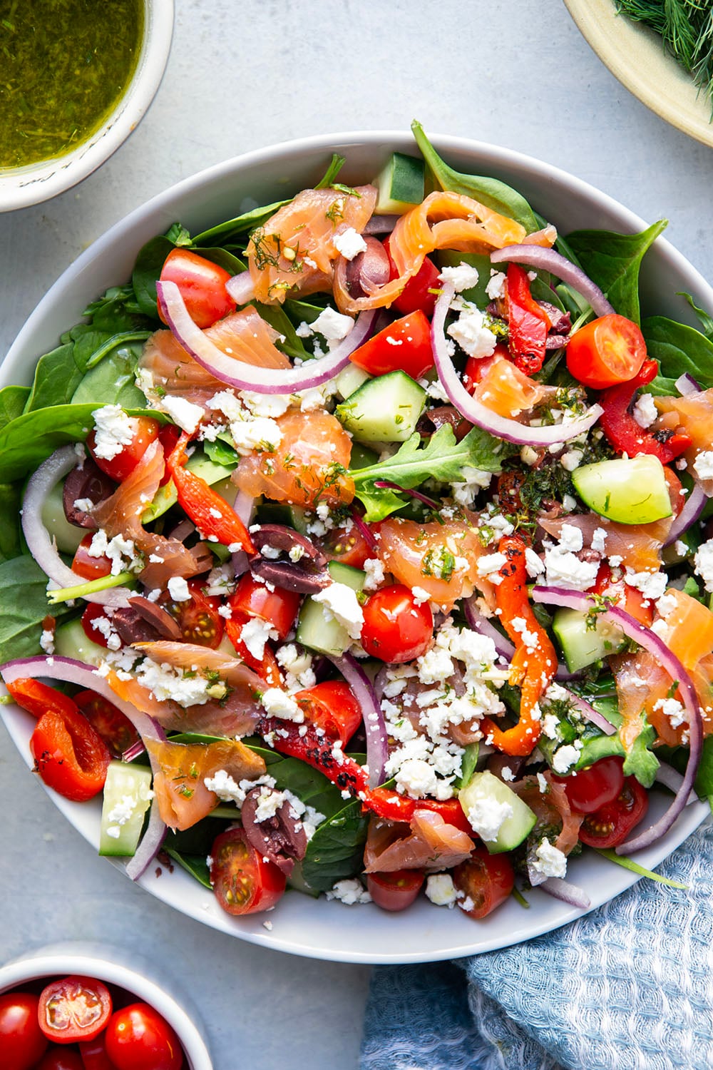 This smoked salmon Greek salad is a twist on the classic and features flavorful smoked salmon with a tangy lemon dill vinaigrette tossed with greens and lots of Greek ingredients.