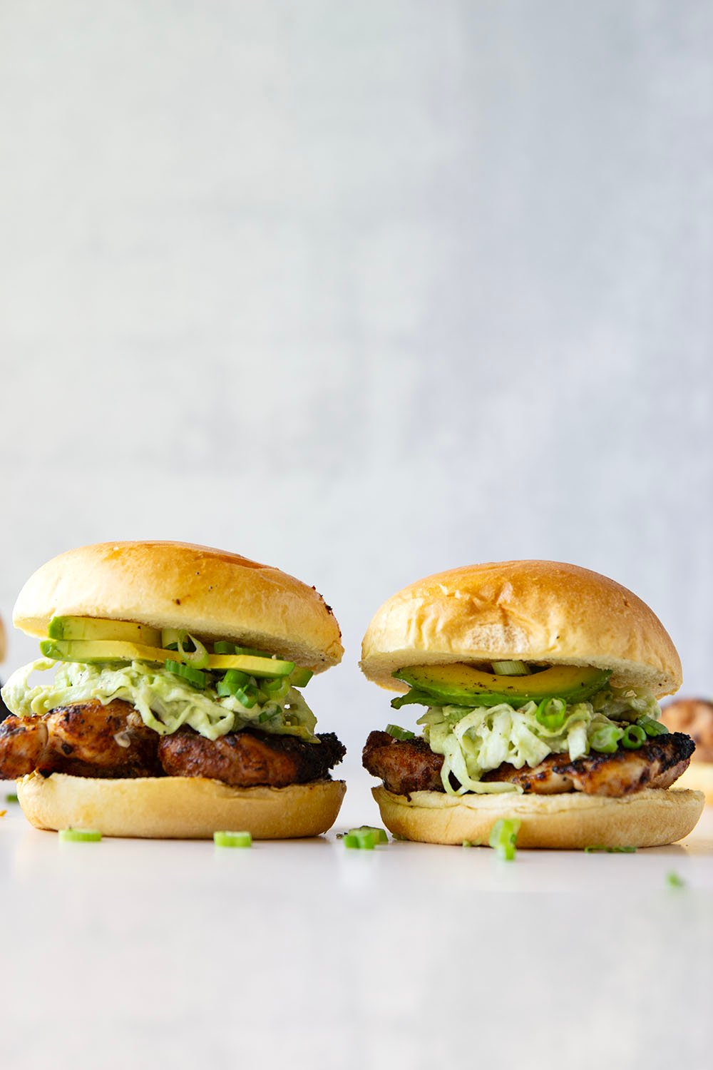 Juicy grilled blackened chicken thighs are stuffed between buns with lots of creamy avocado slaw. This blackened chicken sandwich will quickly become a favorite!