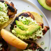 Juicy grilled blackened chicken thighs are stuffed between buns with lots of creamy avocado slaw. This blackened chicken sandwich will quickly become a favorite!