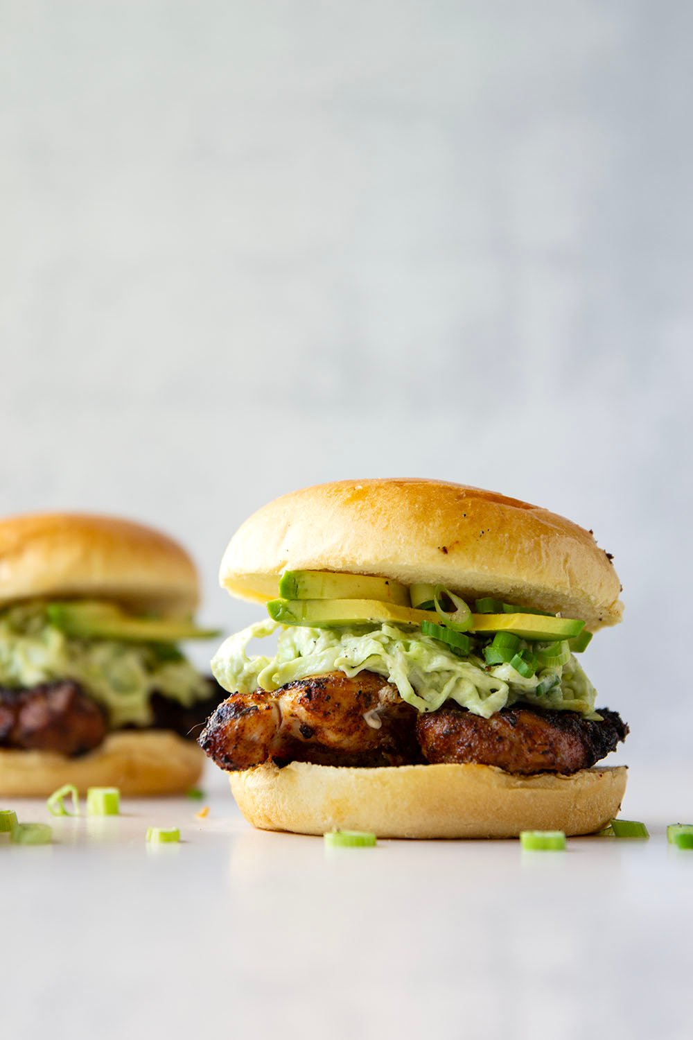 Juicy grilled blackened chicken thighs are stuffed between buns with lots of creamy avocado slaw. This blackened chicken sandwich will quickly become a favorite!
