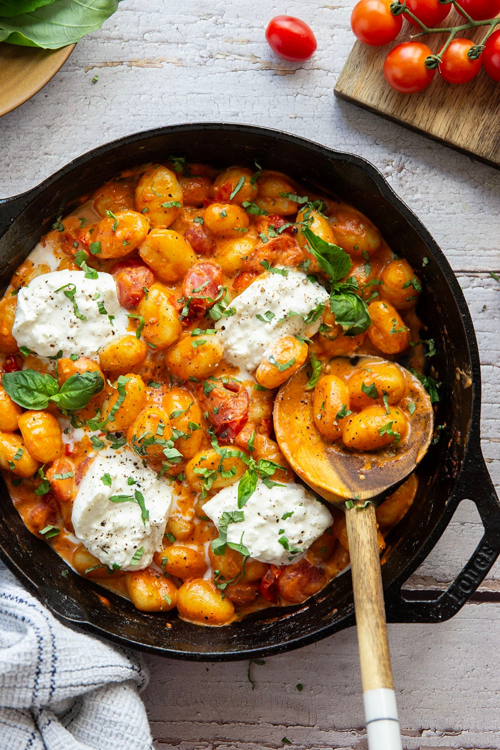 A creamy fresh cherry tomato sauce coats every inch of pillowy gnocchi in this summery burst tomato gnocchi that's topped with lots of fresh basil and rich burrata cheese.